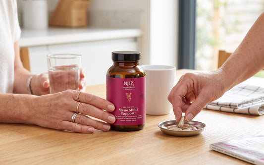 NHP Meno Support Multi supplement with a glass of water